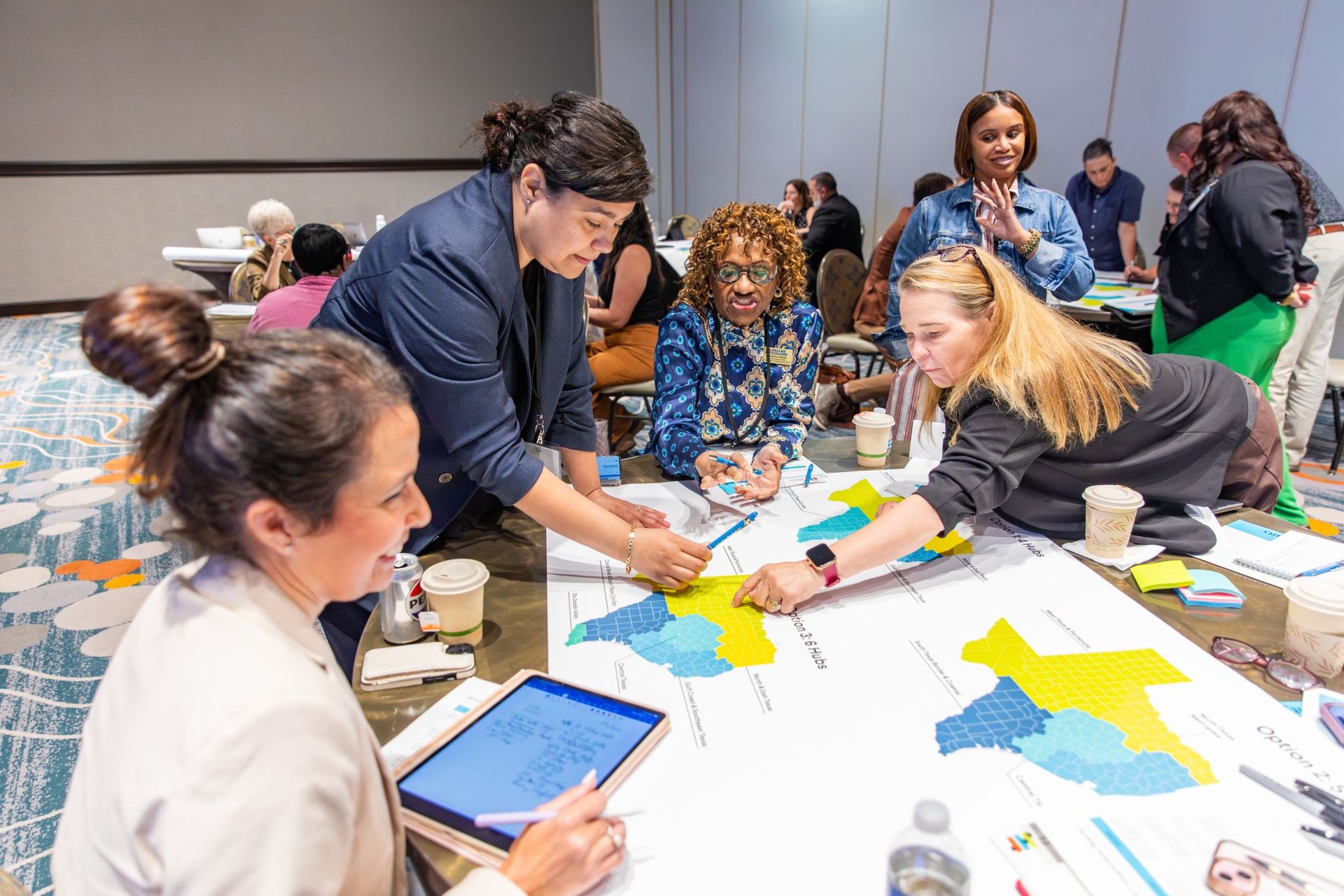 Participants collaborating with maps at the Fair Chance to Advance convening