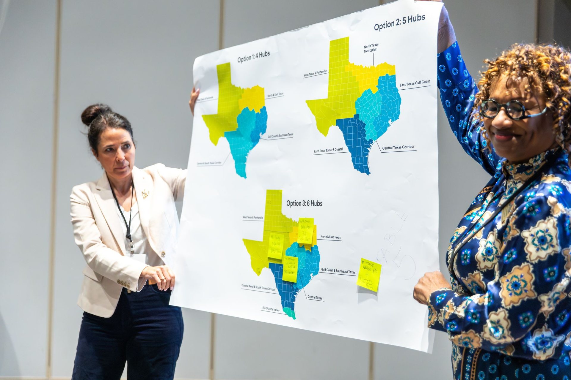 Participants presenting regional hub options on a large map of Texas