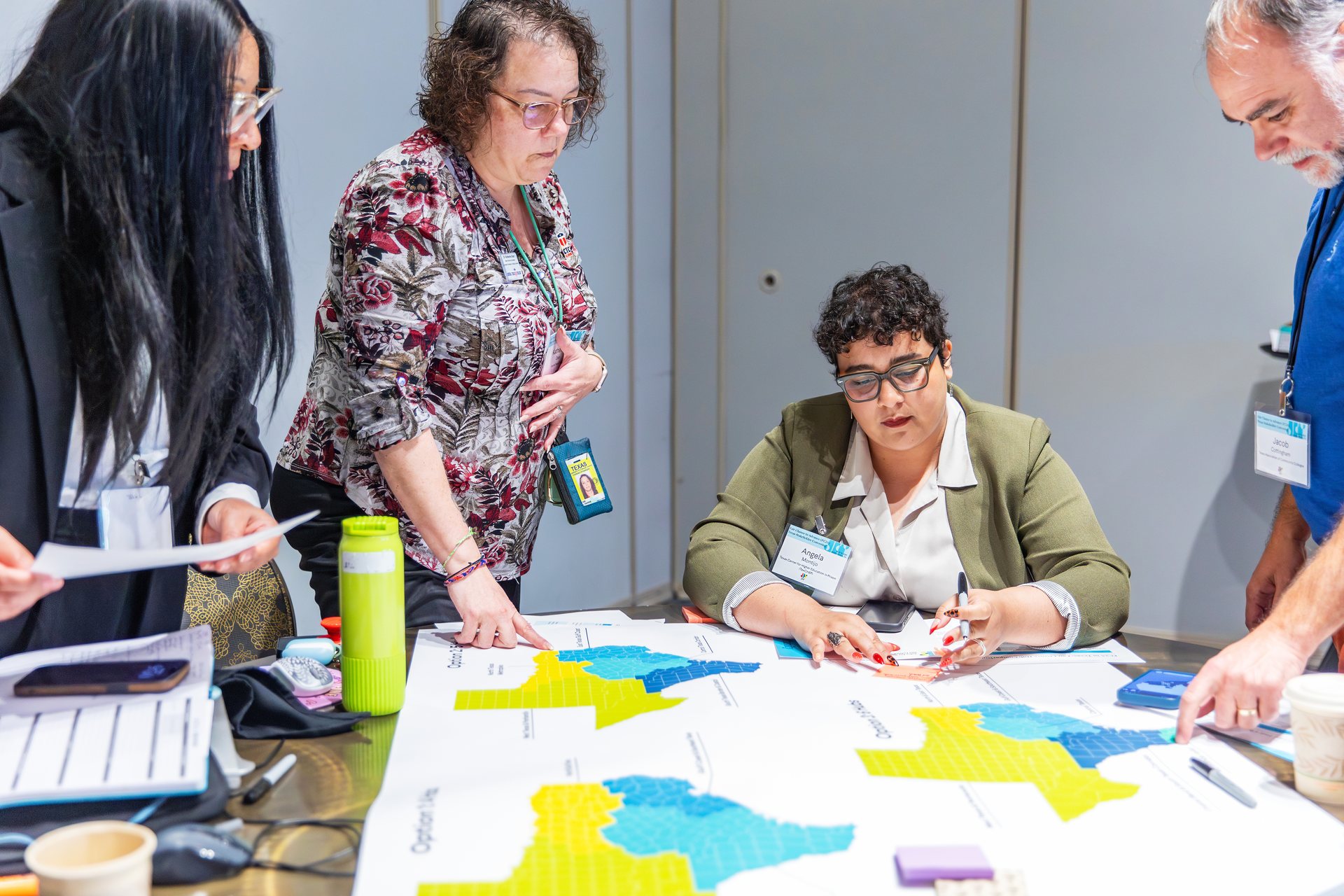 Angela Montijo and other participants working with maps and planning materials